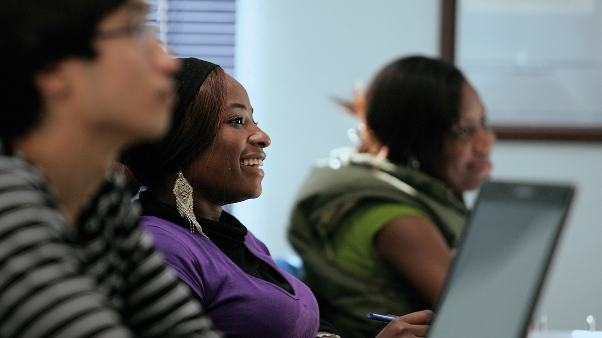 A culturally diverse group of students listen to a lecture