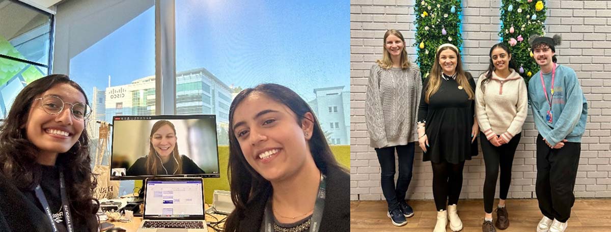 Students smiling and standing in front of a computer.