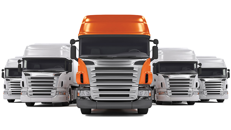 Orange truck flanked by grey trucks